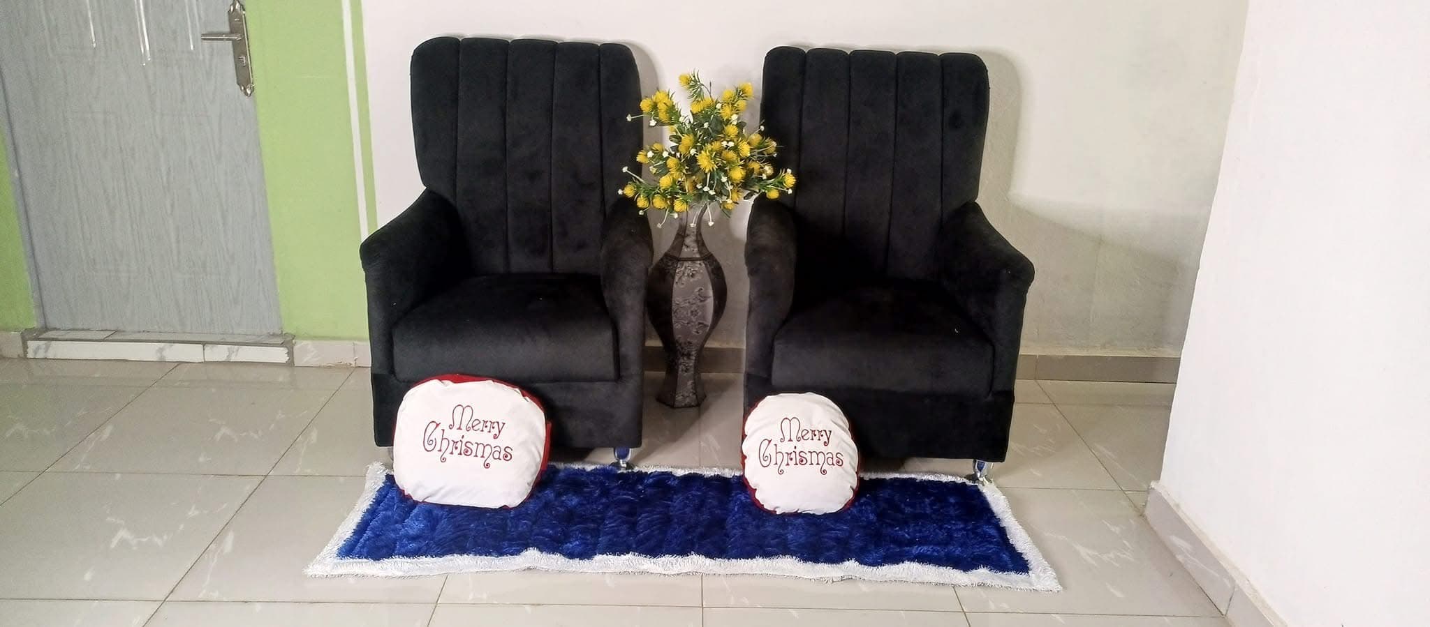 Blue rug styled in a lounge with armchairs
