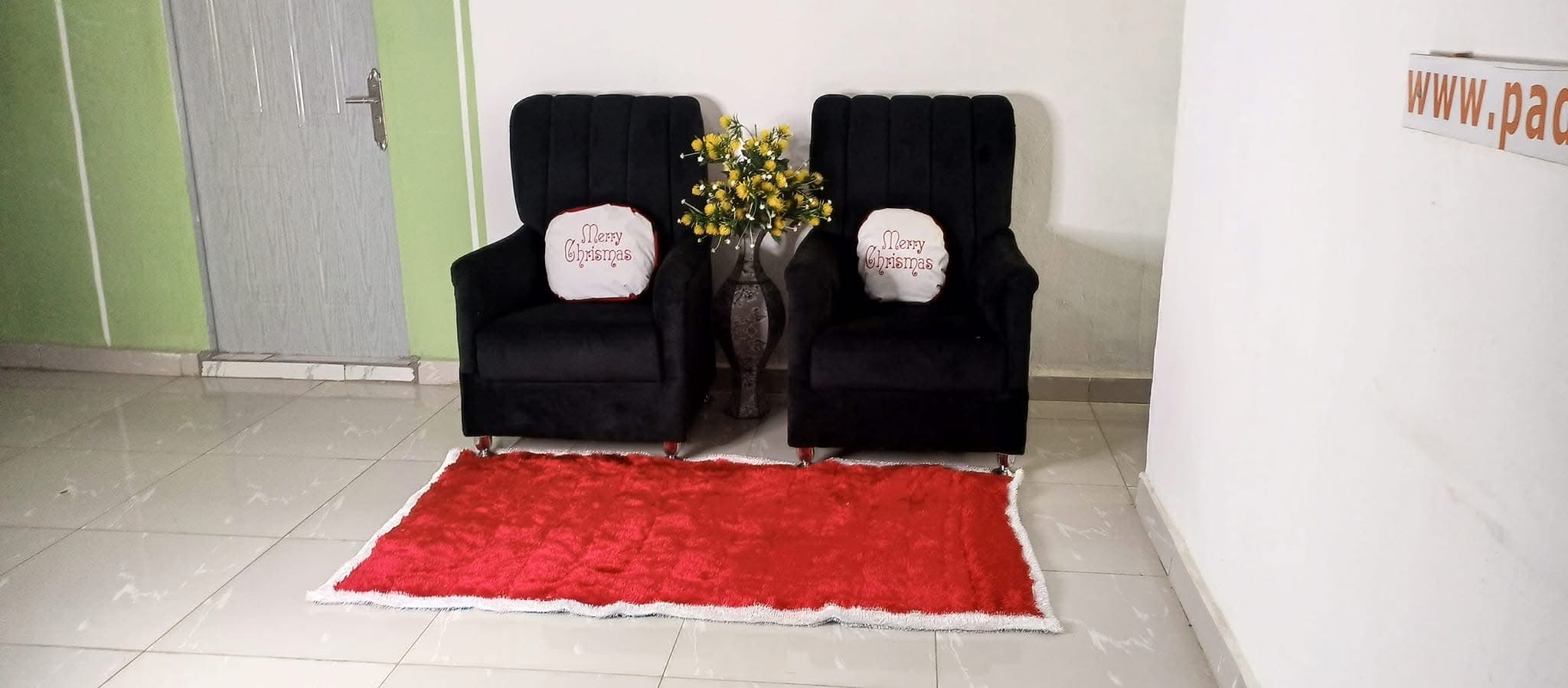 Red rug styled in a lounge with armchairs