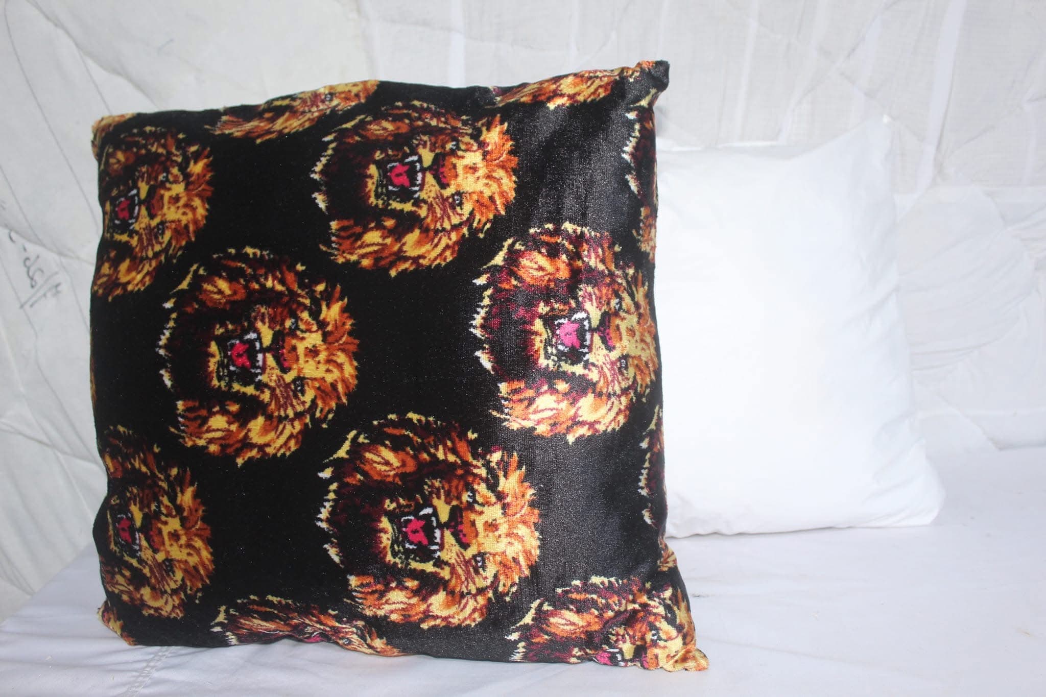 Floral print throw pillow styled on a bed